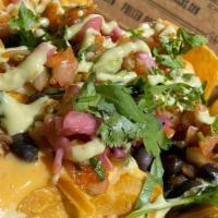 Loaded Street Nachos · Topped with your choice of chicken, pork, steak, or shrimp, garnished with fresh cilantro, f...