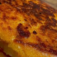 Sweet Corn Arepa With Cheese · Melted mozzarella cheese between 2 sweet and savory corn arepas.