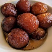 Gulab Jamun · Flour dough dumplings in honey sugar syrup flavored with cardamom.