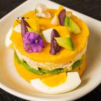 Chicken Causa · Yellow pepper and lime pressed potatoes stuffed with sliced avocado, fresh tomatoes, and shr...