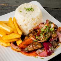 The Real Lomo Saltado · Sauteed and flamed sirloin steak, red onions, beef steak tomatoes served with white rice and...