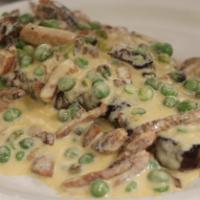 Bistec Borracho · Grilled steak topped with our tequila creamy sauce, green peas and chorizo.