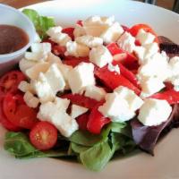 Insalata Caprese · Mixed baby greens, fresh Mozzarella, grape tomatoes, and roasted peppers in our house balsam...