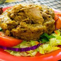 Mofongo (Fried Green Plantains Mashed With Pork Rhine) · Served with a (garlic or tomato sauce).