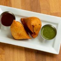 Samosa · Deep fried pastry with savory potato and cauliflower filling, served with mint and tamarind ...