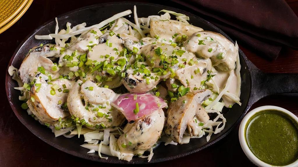 Mushroom Malai Wali · Skewered mushrooms in a creamy marinade, cooked to perfection in a traditional tandoor oven