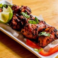 Pahadi Murgh Kebab · Skewered chicken chunks in a spicy chili paste marinade, cooked to perfection in a tradition...