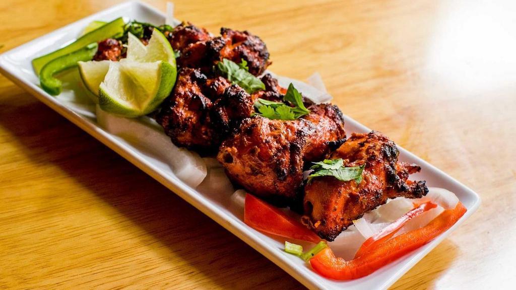 Pahadi Murgh Kebab · Skewered chicken chunks in a spicy chili paste marinade, cooked to perfection in a traditional tandoor oven