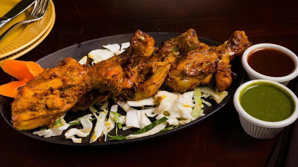 Tangri Kebab · Skewered chicken drumsticks in a creamy marinade, cooked to perfection in a traditional tandoor oven