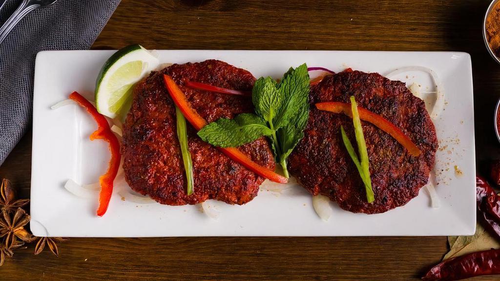 Chapli Kebab · Tender lamb patties spiced with a blend of coriander and green chilies