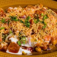 Samosa Chaat · Deep fried pastry with savory potato and cauliflower filling, served with curried chickpeas,...