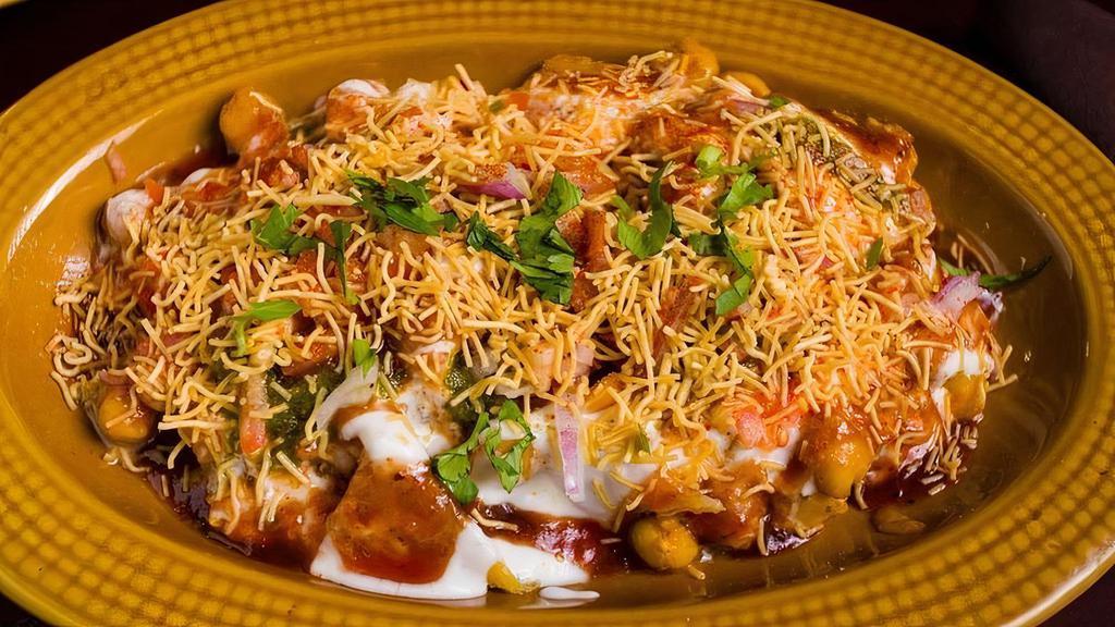 Samosa Chaat · Deep fried pastry with savory potato and cauliflower filling, served with curried chickpeas, yogurt, and mint and tamarind chutnies