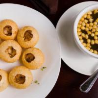 Pani Puri · Deep fried crunchy puri with potato and chickpea filling, served cold with tangy tamarind wa...