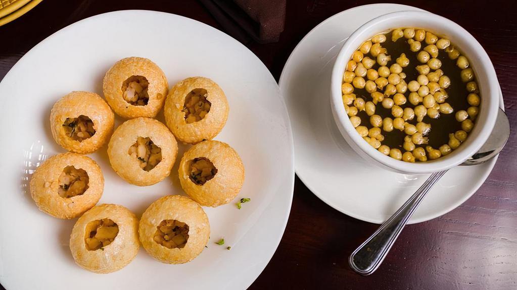 Pani Puri · Deep fried crunchy puri with potato and chickpea filling, served cold with tangy tamarind water on the side