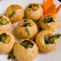Batata Sev Puri · Deep fried crunchy puri with chickpea filling, served cold with yogurt, chutnies, and thin g...