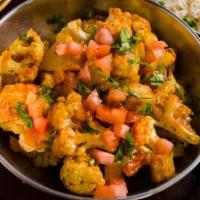 Tawa Aloo Gobi · Cauliflower and potatoes cooked with fenugreek and a blend of Indian spices in a flat cast i...