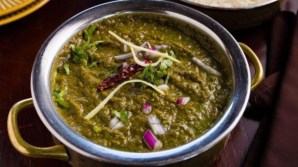 Sarson Da Saag · Pureed mustard greens and spinach, cooked in clarified butter with ginger, garlic, onions, and green chilies