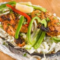 Murgh Tandoor · Tandoor style skewered bone-in chicken chunks marinated in yogurt and blend of Indian spices...