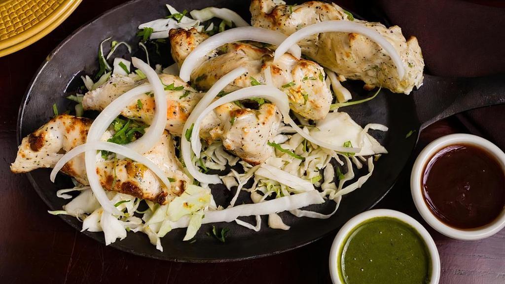Murgh Malai Kabab · Skewered spring chicken in a mild creamy marinade, cooked in a traditional tandoor oven (20 minutes preparation time)