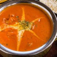 Malai Marke Butter Chicken · Chicken cooked in a creamy onion and tomato sauce with bell peppers and clarified butter