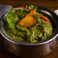 Sarson Wali Fish · Curried fish cooked with creamy pureed mustard greens and spinach