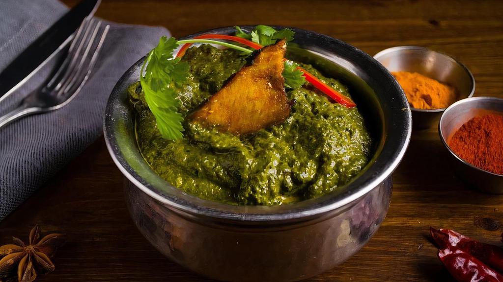 Sarson Wali Fish · Curried fish cooked with creamy pureed mustard greens and spinach