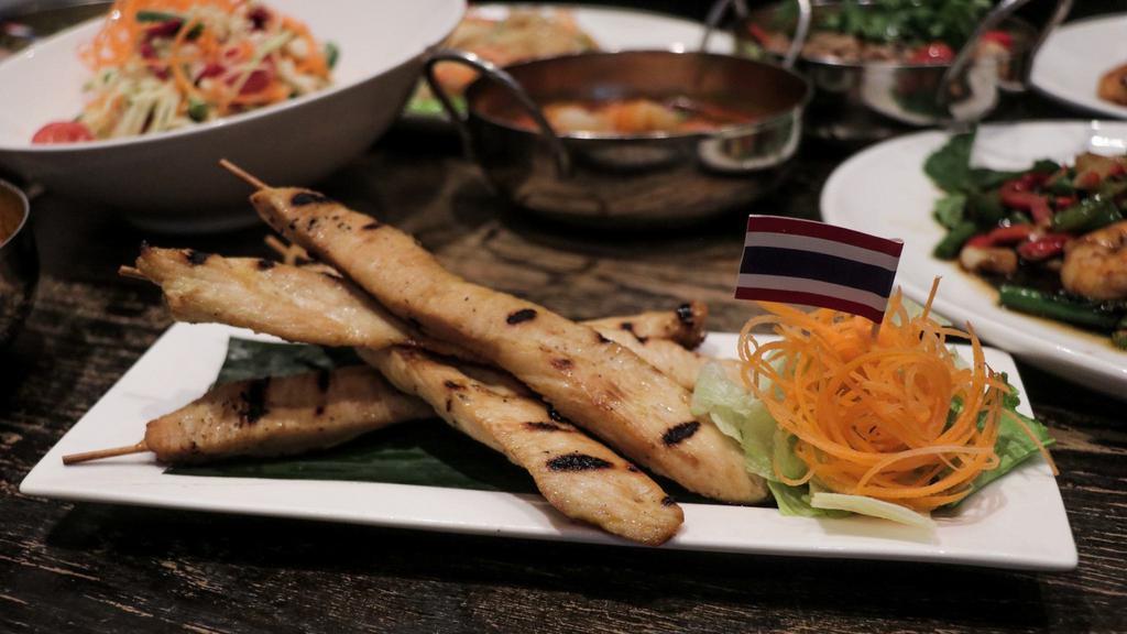 Chicken Satay (4 Skewers) · Grilled marinated chicken on skewers. Served with peanut sauce and cucumber sauce.