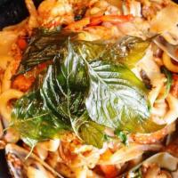 Drunken Noodle · Sautéed flat rice noodle with chilli basil sauce, egg, onions, bell-peppers, basil, and toma...
