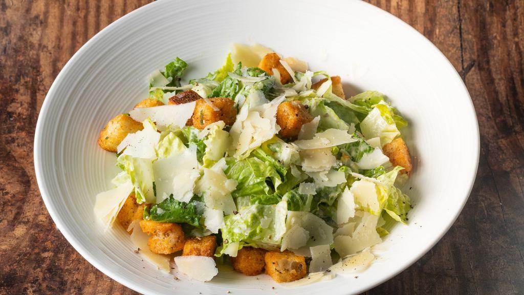 Caesar Salad · Chopped Romaine lettuce, tossed with garlic croutons, parmesan. cheese shavings, and Caesar dressing.