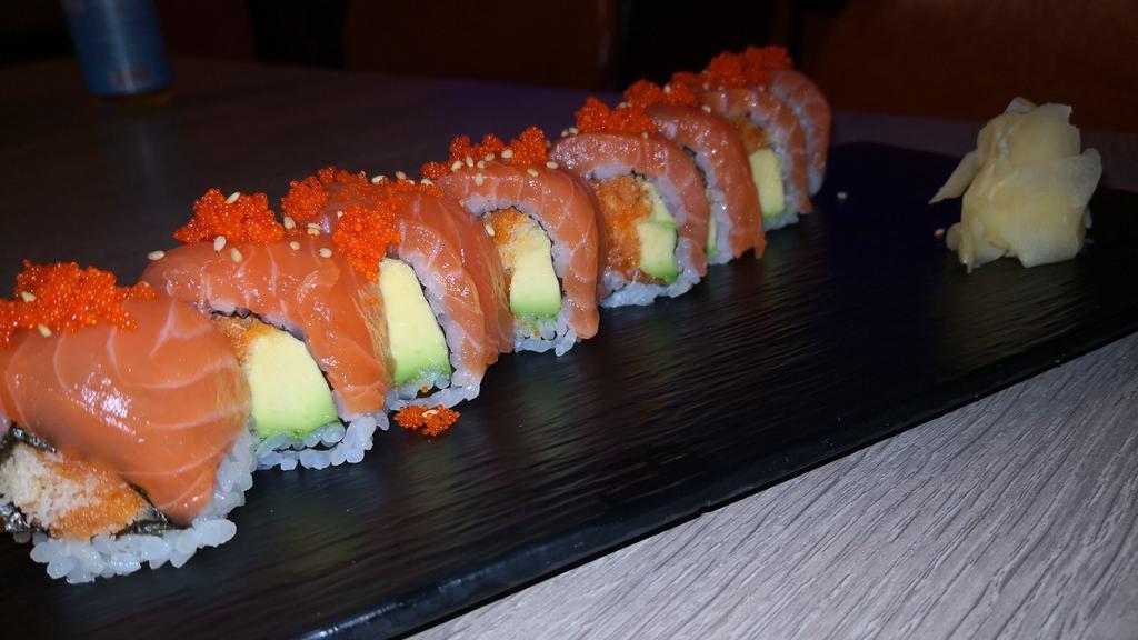 Sake Roll · 8pcs. Spicy salmon, avocado wrapped with salmon and smelt roe on top.