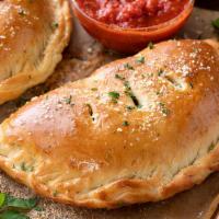 Meatball Calzone · A baked or fried turnover of pizza dough stuffed with savory fillings.
