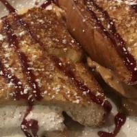 Fluffernutter French Toast · Stuffed with chunky peanut butter and marshmallow topping. Drizzled with chocolate syrup and...