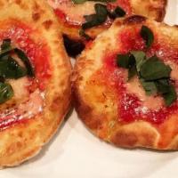 Montanara · Fried small pizzas, house tomato sauce, grana padano, basil.