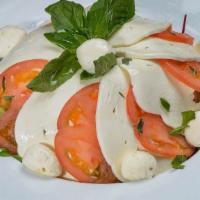 Caprese · Fresh mozzarella, tomatoes, basil and drizzled with olive oil.