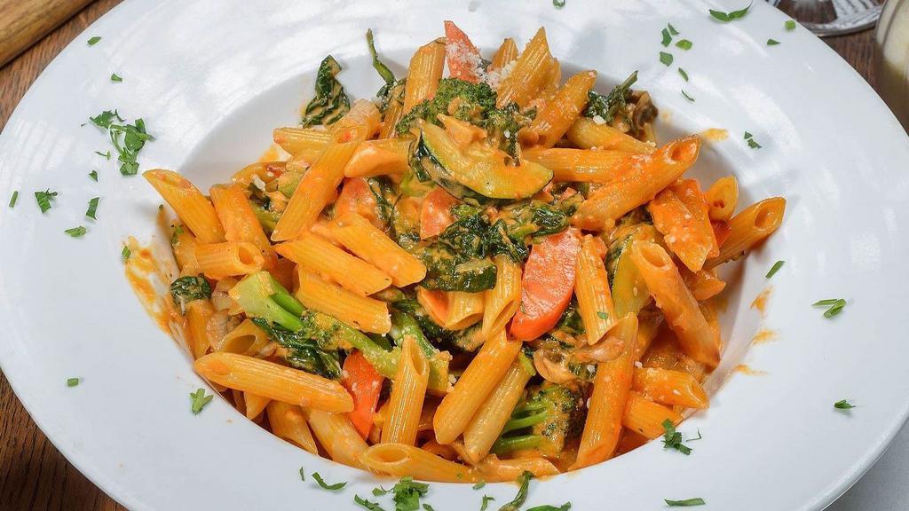 Penne Primavera · Mixed vegetables in a light pink sauce.