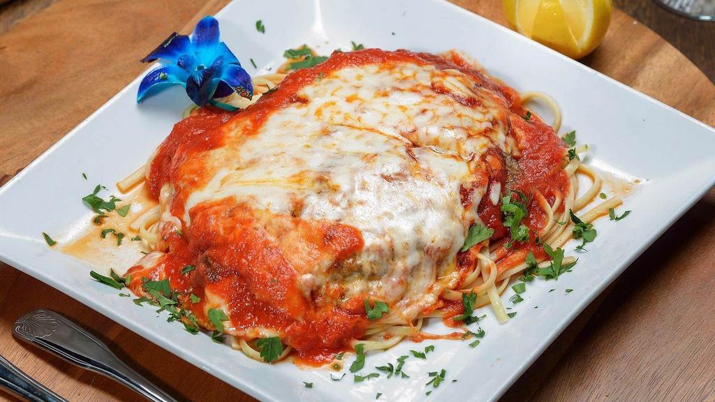 Eggplant Parmigiana · Lightly breaded skinless eggplant covered with tomato sauce and mozzarella. Served with your choice of side.