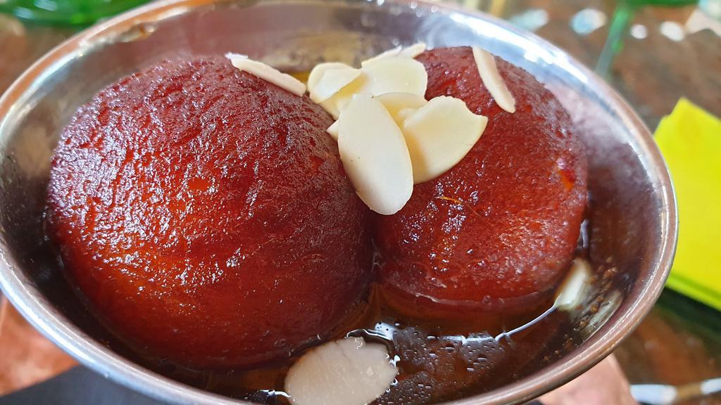 Gulab Jamun · Three pieces. Indian sweet dumplings made with dried milk and dipped in rose flavored sugar syrup.