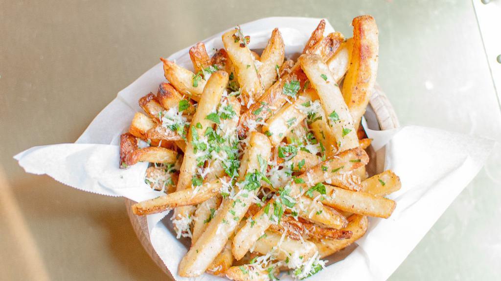 Truffle Fries · Tossed in 5 months aged grated parmesan cheese, parsley, black truffle oil drizzle.
