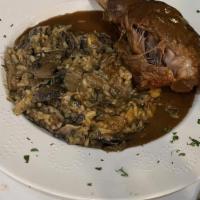 Braised Lamb Shank · Served with tri fungi mushroom risotto in a sherry wine sauce.