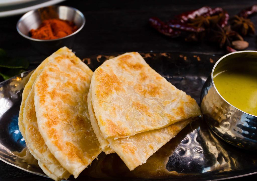 Roti Paratha - Flaky Bread With Curry Dip · Flipped crispy and fluffy thin bread served with curry dip.