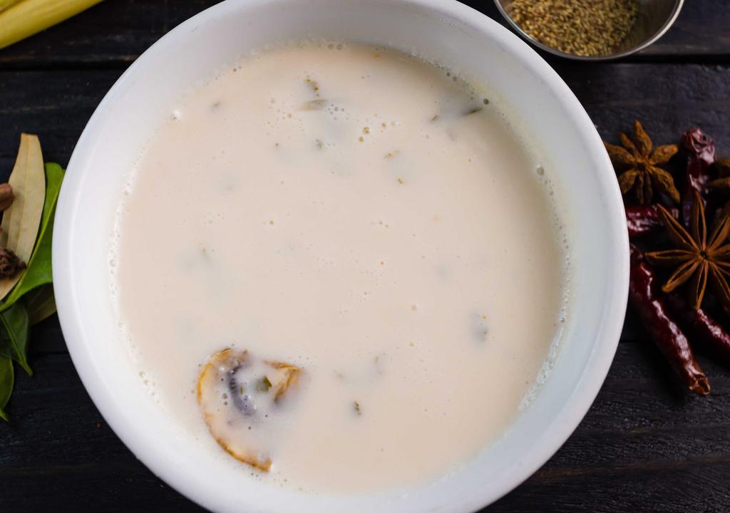Tom Kha - Creamy Soup · Gluten free. Creamy coconut milk broth-lemon grass galangal-lime-oyster mushrooms-tomato sliced red onion.