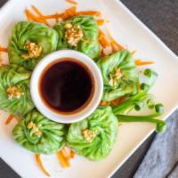 Emerald Veggie Dumpling · Green wonton skin stuffed with vegetables served with spicy soy source.