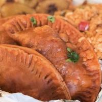 Empanada Meal · Three vegan beef empanadas served with arroz con gandules (rice) and fried plantains.