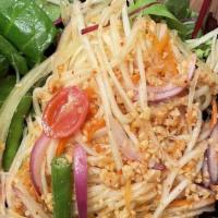 Papaya Salad · Shredded papaya, red onions, carrot, string beans, tomato, and crushed peanut in spicy lime ...