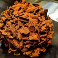 Hazelnut Bomb · A chocolate sponge cake dome with a heart of chocolate hazelnut cream all covered with choco...