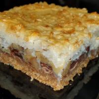 Coconut Magic Bar · Shredded coconut, walnuts and chocolate chips caramelized in layers in a graham cracker crust