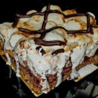 S'Mores Bar · Graham cracker crust, marshmallows, rich ganache, topped with torched meringue and chocolate...
