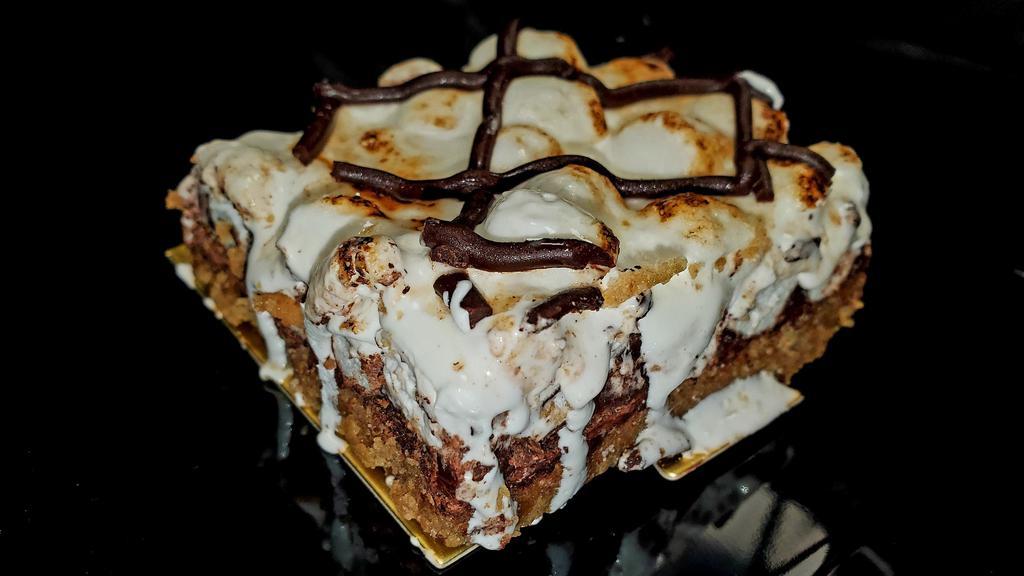 S'Mores Bar · Graham cracker crust, marshmallows, rich ganache, topped with torched meringue and chocolate fudge drizzle
