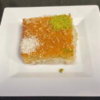 Basbousa · Sweet semolina cake soaked in syrup, drizzled with pistachios and coconut