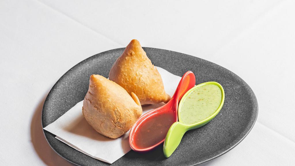 Samosa (Veg) · Crispy pastry turnover stuffed with spiced potatoes and peas.
